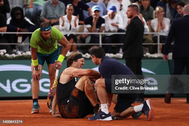 Alexander Zverev of Germany receives medical attention following an injury against Rafael Nadal of Spain during the Men's Singles Semi Final match on...