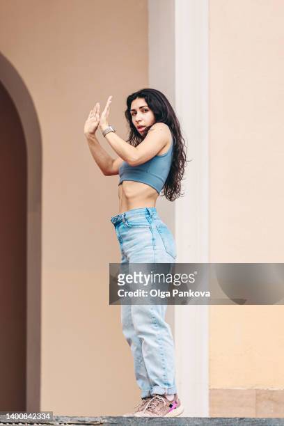 multi-racial young woman dancing on the street. - beautiful armenian women stock pictures, royalty-free photos & images