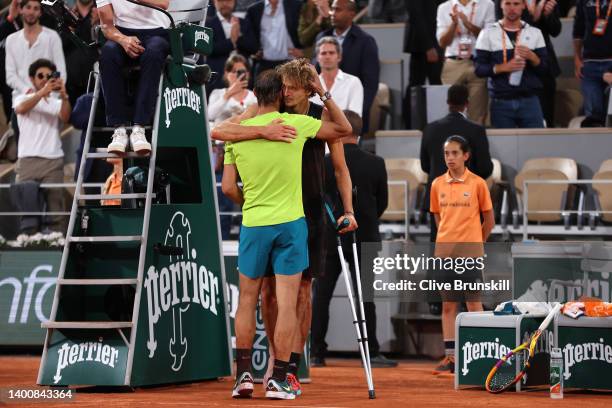 Alexander Zverev of Germany and Rafael Nadal of Spain embrace each other as Alexander Zverev of Germany is being forced to retire following an injury...