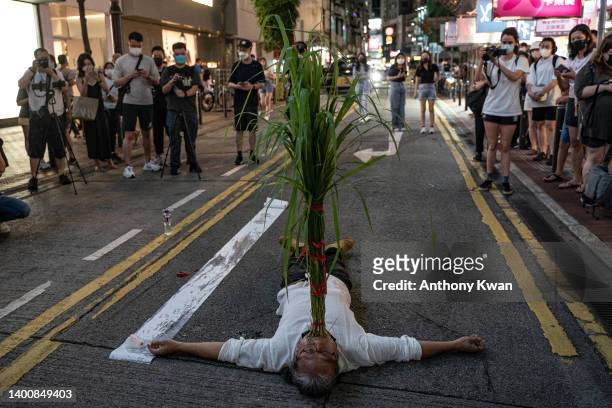 An artist demonstrates a performance arts on a street ahead of the 33rd anniversary of Tiananmen Square incident on June 03, 2022 in Hong Kong,...