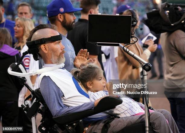 Steve Gleason, a sufferer of Amyotrophic Lateral Sclerosis , watches pregame ceremonies with his daughter Gray, 3 prior to a game between the Chicago...
