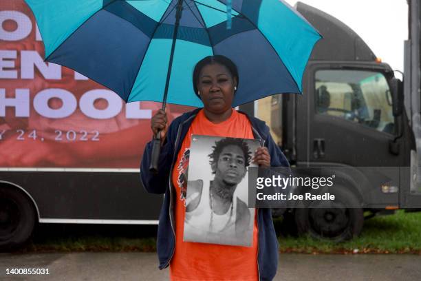 Romania Dukes holds a photo of her son De'Michael Dukes, who was murdered by a gunman in 2014, attends a protest near the office of Sen. Marco Rubio...
