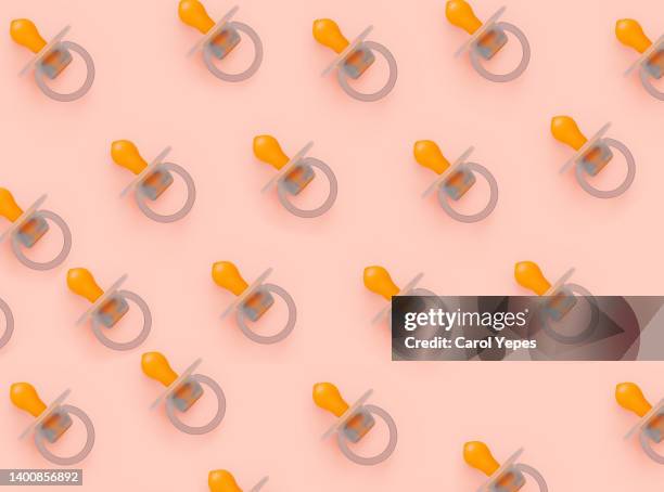 pink pacifier seamless pattern - おしゃぶり ストックフォトと画像