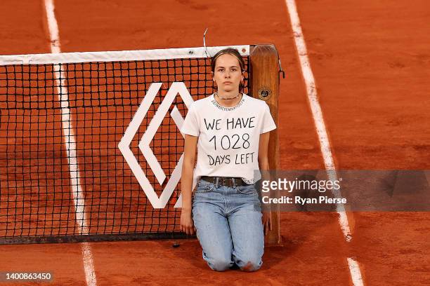 Protester ties themselves to the net during the Men's Singles Semi Final match between Marin Cilic of Croatia and Casper Ruud of Norway on Day 13 of...