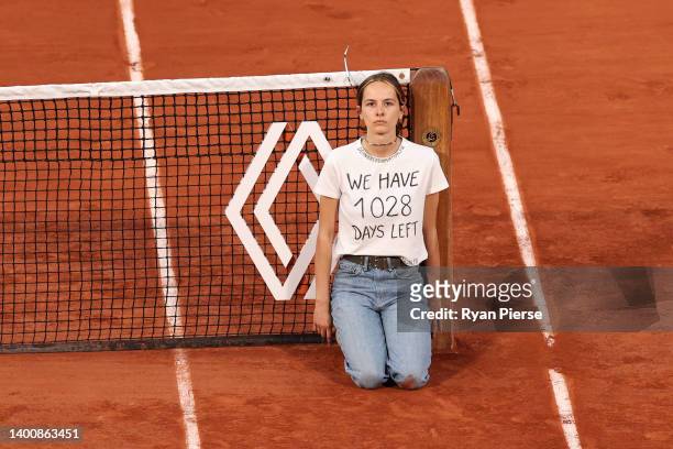 Protester ties themselves to the net during the Men's Singles Semi Final match between Marin Cilic of Croatia and Casper Ruud of Norway on Day 13 of...