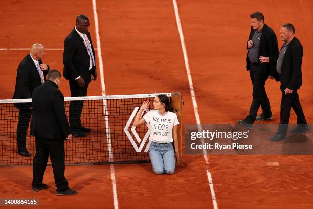 Protester ties themselves to the net during the Men's Singles Semi Final match between Marin Cilic of Croatia and Casper Ruud of Norway on Day 13 of...