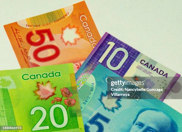 canadian paper currency in different denominations. - canadian money stock pictures, royalty-free photos & images