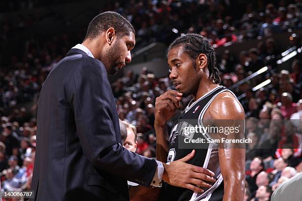 Tim Duncan and Kawhi Leonard of the San Antonio Spurs share a few words during the game against the Portland Trail Blazers on February 21, 2012 at...
