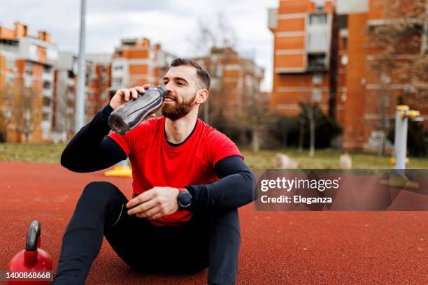 fit man drinking water after intensive work out - drink milkshake stock pictures, royalty-free photos & images
