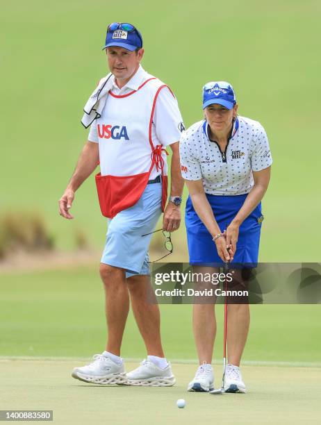 Annika Sorenstam of Sweden lines up a putt with her husband and caddie Mike McGee on the first hole during the second round of the 2022 U.S.Women's...