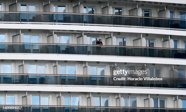 Tourist stands alone in a cabin balcony as MS Nieuw Statendam, a 99,902 GT Pinnacle-class cruise ship operated by Holland America Line , a division...