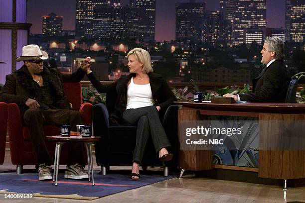 Episode 1752 -- Pictured: Basketball player Dennis Rodman and Actress Charlize Theron during an interview with host Jay Leno on January 3, 2000 --