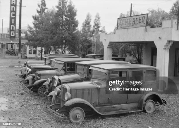 Roadside used car display on State Highway 17, in season when migrants come into region for pea-picking. Santa Clara County, California. Artist...