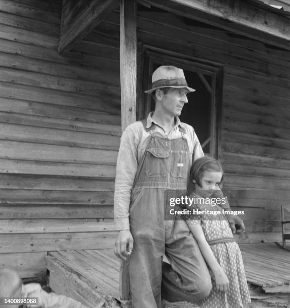 Tobacco sharecropper with his oldest daughter. Person County, North Carolina. Artist Dorothea Lange.