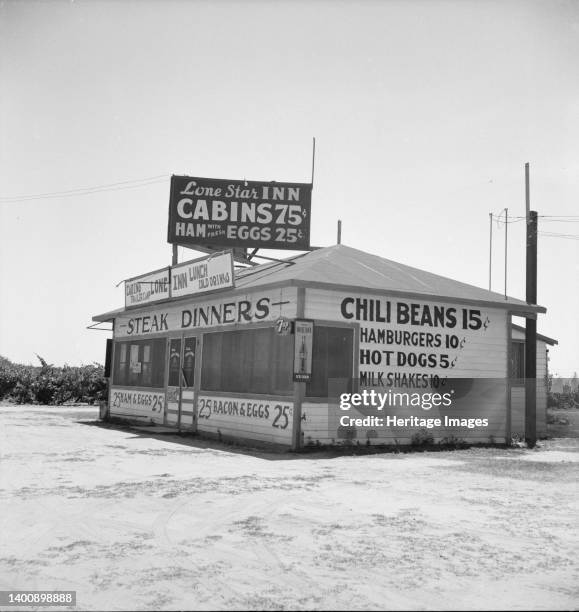 Between Tulare and Fresno on U.S. 99. A large variety and great number of small eating places face the highway. This one is managed by ex-Texans,...