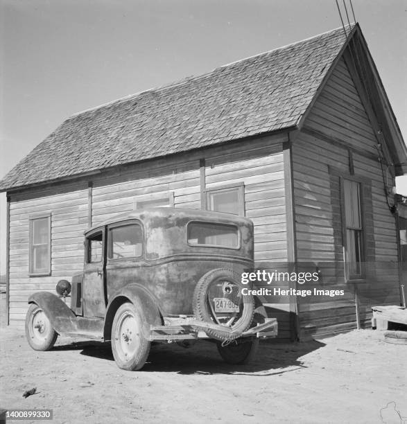 New home of Schroeder family. They left South Dakota three years ago in this car. Dead Ox Flat, Malheur County, Oregon. Artist Dorothea Lange.