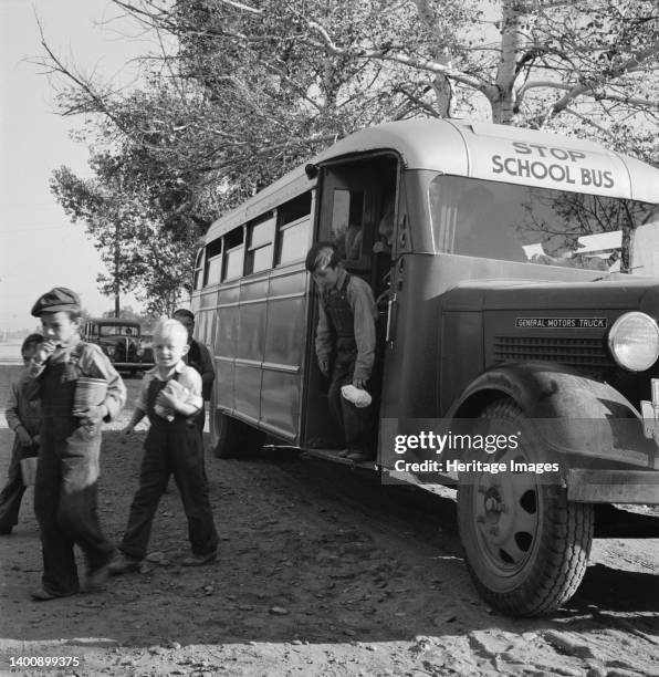 The children from Dead Ox Flat get off bus at school yard. Ontario, Malheur County, Oregon. Artist Dorothea Lange.