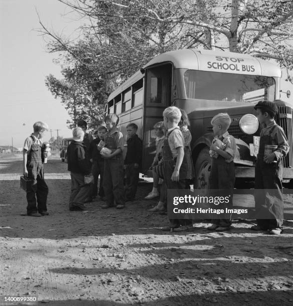 The children from Dead Ox Flat get off bus at school yard. Ontario, Malheur County, Oregon. Artist Dorothea Lange.