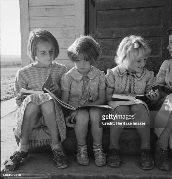 Girls of Lincoln Bench School study their reading lesson. Near Ontario, Malheur County, Oregon. Artist Dorothea Lange.