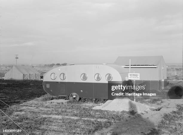 Infirmary. Nyssa farm family labor camp. Mobile unit at opening of beet campaign. Malheur County, Oregon. FSA camp. [Sign: 'Infirmary - Offices Hours...