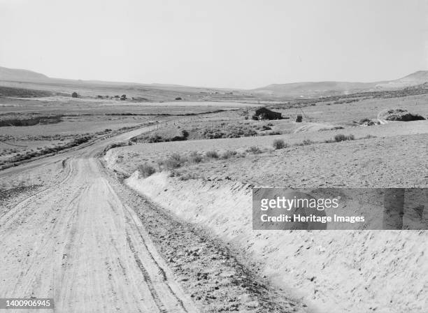 Entering Cow Hollow region in which practically all are FSA borrowers. These are farmers who had a late start. Malheur County, Oregon. Artist...