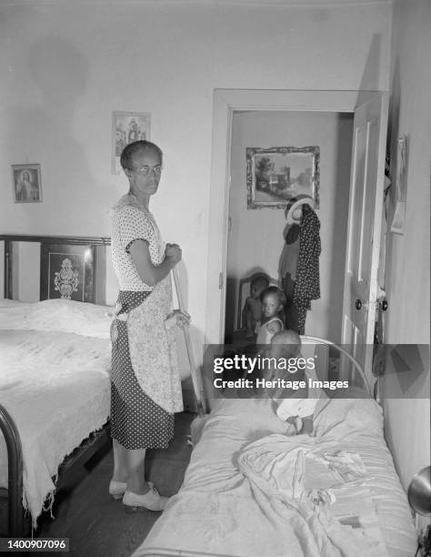 Washington, D.C. Grandchild of Mrs. Ella Watson, a government charwoman, taking her afternoon nap. Artist Gordon Parks.