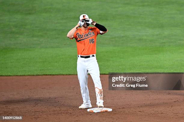 Trey Mancini of the Baltimore Orioles celebrates at second base after driving in two runs with a double in the eighth inning against the Cleveland...