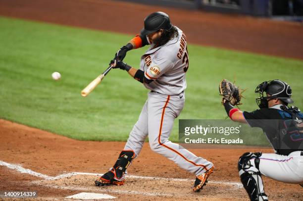 Brandon Crawford of the San Francisco Giants hits a grand slam in the seventh inning against the Miami Marlins at loanDepot park on June 03, 2022 in...