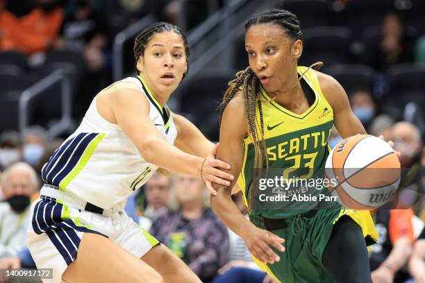 Kiana Williams of the Seattle Storm works towards the basket against Veronica Burton of the Dallas Wings during the second quarter at Climate Pledge...