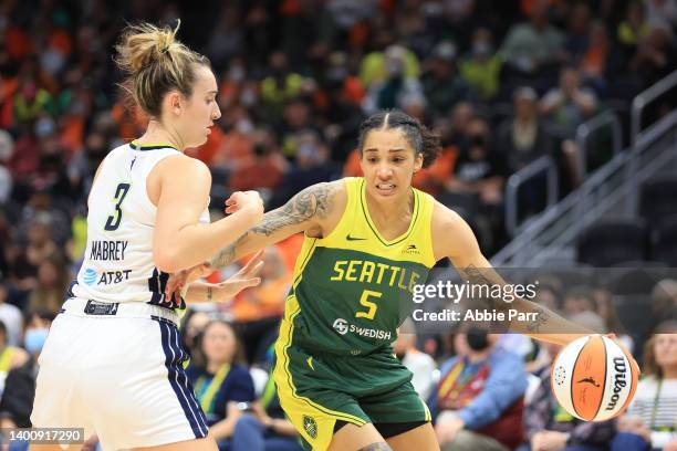 Gabby Williams of the Seattle Storm handles the ball against Marina Mabrey of the Dallas Wings during the second quarter at Climate Pledge Arena on...