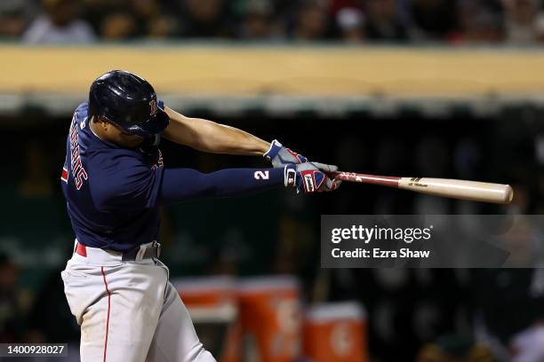 Xander Bogaerts of the Boston Red Sox hits a double that scored two runs in the ninth inning against the Oakland Athletics at RingCentral Coliseum on...