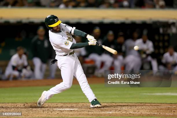 Jed Lowrie of the Oakland Athletics hits a double that scored two runs in the eighth inning against the Boston Red Sox at RingCentral Coliseum on...