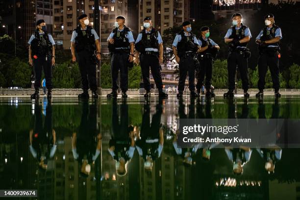 Police officers set up a cordon as they disperse public out of the Victoria Park ahead of the 33rd anniversary of Tiananmen Square incident on June...