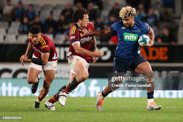 Hoskins Sotutu of the Blues fends during the quarter final Super Rugby Pacific match between the Blues and the Highlanders at Eden Park on June 04,...