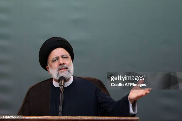 Iranian President Ebrahim Raisi delivers a speech on the eve of the 33rd anniversary of Ayatollah Khomeini's death at his grave outside Tehran, on...