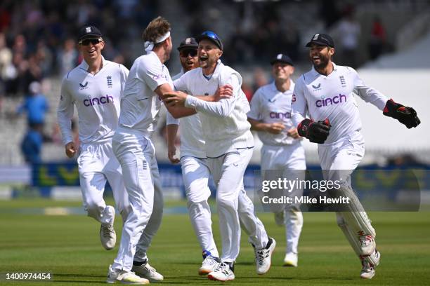 Stuart Broad of England celebrates with Joe Root after bowling Kyle Jamieson of New Zealand during Day 3 of the First LV= Insurance Test Match...