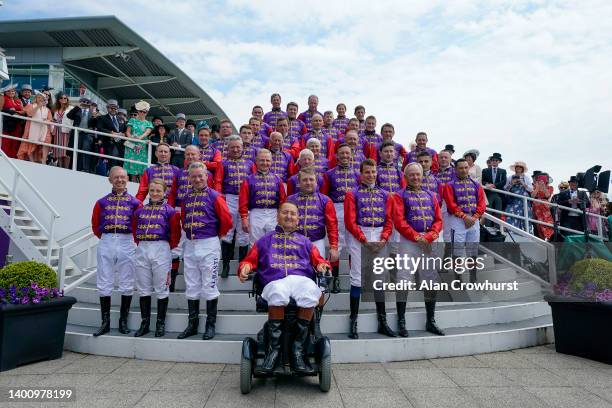 General view as current and former jockeys who have ridden for Queen Elizabeth II proudly wear her silks line up for a photo as she celebrates her...