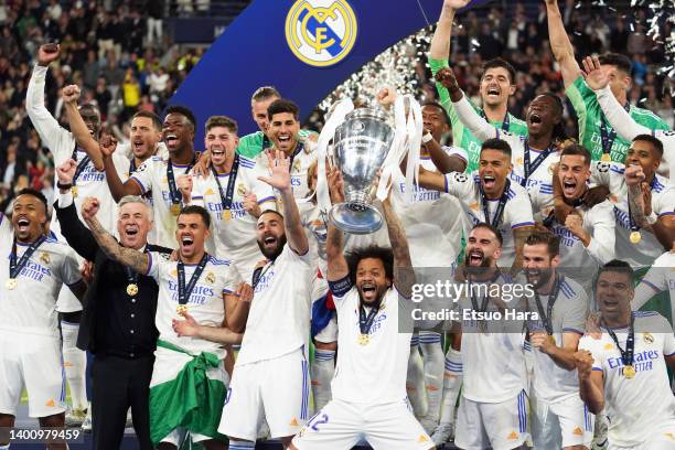 Players of Real Madrid celebrate their victory as Marcelo lifts the trophy following the UEFA Champions League final match between Liverpool FC and...