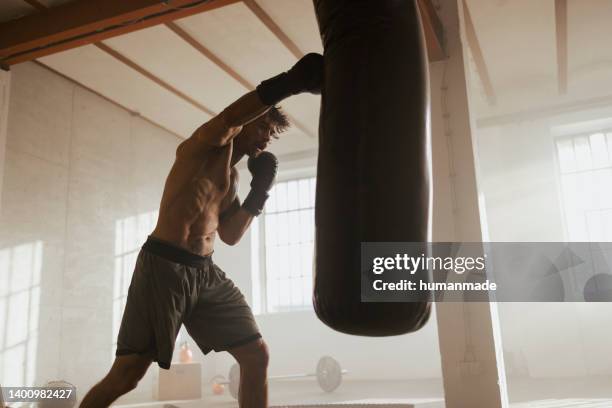 fit young man boxing in the gym - boxboll bildbanksfoton och bilder