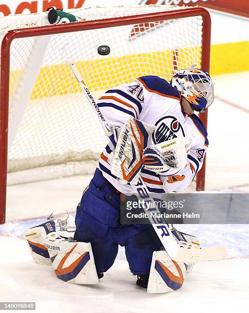 Devan Dubnyk of the Edmonton Oilers gets the puck deflected off him during a shot on goal in a game against the Winnipeg Jets in NHL action at the...
