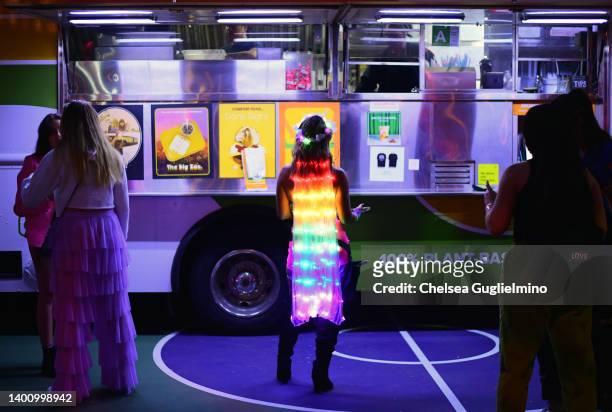 An attendee waits at a food truck during Outloud Raising Voices Music Festival at WeHo Pride on June 03, 2022 in West Hollywood, California.