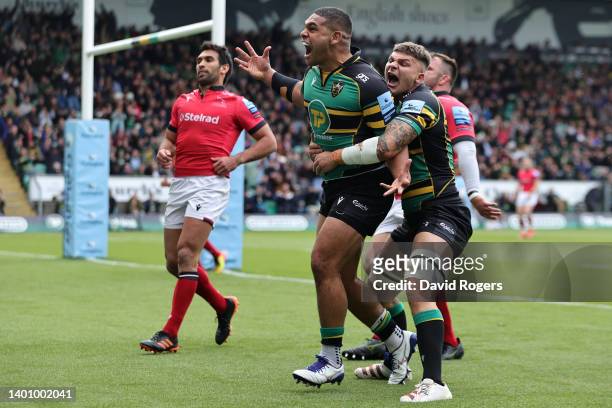 Sam Matavesi celebrates with teammate Aaron Hinkley of Northampton Saints scoring their sides first try during the Gallagher Premiership Rugby match...