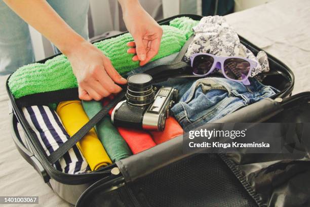 packing a suitcase - holiday packing stockfoto's en -beelden