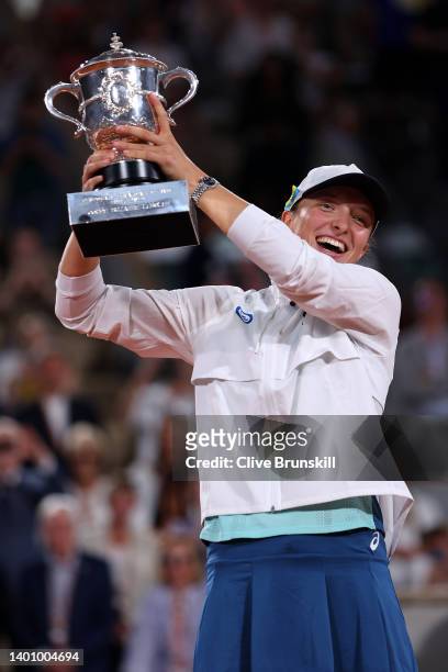 Iga Swiatek of Poland celebrates with the trophy after winning against Coco Gauff of The United States during the Women’s Singles final match on Day...