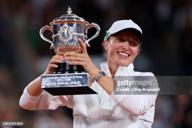 Iga Swiatek of Poland celebrates with the trophy after winning against Coco Gauff of The United States during the Women’s Singles final match on Day...