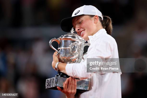 Iga Swiatek of Poland celebrates with the trophy after winning against Coco Gauff of The United States during the Women’s Singles final match on Day...