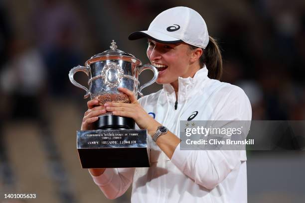 Iga Swiatek of Poland celebrates with the trophy after winning against Coco Gauff of The United States during the Women’s Singles final match on Day...