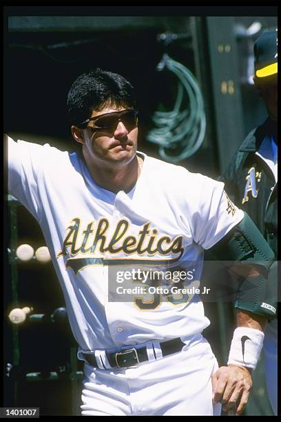 Outfielder Jose Canseco of the Oakland Athletics stands on the field during a game against the Minnesota Twins at the Oakland Coliseum in Oakland,...