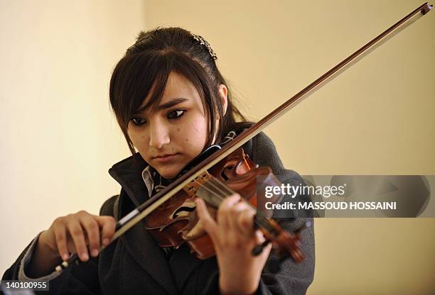 Entertainment-Afghanistan-unrest-music,FEATURE by Claire Truscott This picture taken on January 29, 2012 shows an Afghan youth playing the violin at...