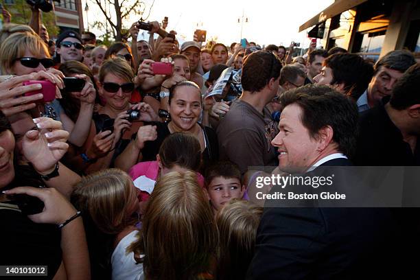 Actor Mark Wahlberg poses with fans outside the restaurant Alma Nove in Hingham, where he is hosting a special advance screening of "The Other Guys"...